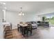 Open living area with L-shaped sofa, dining table, and view to golf course at 13905 Fairway Island Dr # 1022, Orlando, FL 32837