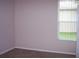 Light pink-walled bedroom with a window and neutral carpeting at 284 Pinestraw Cir, Altamonte Springs, FL 32714