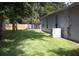 Landscaped backyard with a large grassy area and wooden fence at 284 Pinestraw Cir, Altamonte Springs, FL 32714