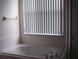 Clean bathroom with white tiled walls, bathtub, and vanity at 284 Pinestraw Cir, Altamonte Springs, FL 32714