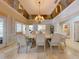 Formal dining room with a large table, chandelier, and mirrored ceiling at 1185 Coachwood Ct, Longwood, FL 32779