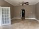 Gathering room with tile floors, a ceiling fan, and an arched doorway at 1185 Coachwood Ct, Longwood, FL 32779