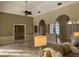 Living room with arched doorways, tile flooring, ceiling fan, and comfortable seating at 1185 Coachwood Ct, Longwood, FL 32779