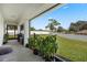 Covered patio with backyard access, potted plants and a grill at 1302 Belmar Ter, Deltona, FL 32725