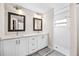 Bathroom with double vanity, white cabinets, and a walk-in shower at 1302 Belmar Ter, Deltona, FL 32725