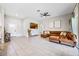 Living room with sectional sofa, tile floors, and access to backyard at 1302 Belmar Ter, Deltona, FL 32725