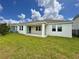 Back exterior view of house with covered patio at 5013 Center Ct, St Cloud, FL 34772