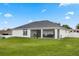 Back exterior view of house with covered patio and fenced yard at 1302 Belmar Ter, Deltona, FL 32725