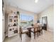 Bright dining room with wood table and chairs, and a built-in shelving unit at 1302 Belmar Ter, Deltona, FL 32725
