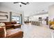 Open concept living room with L-shaped sectional sofa and view of kitchen at 1302 Belmar Ter, Deltona, FL 32725