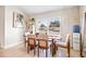Modern dining area with wooden table and neutral colored chairs at 1302 Belmar Ter, Deltona, FL 32725