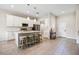 Modern kitchen with white cabinets, island with seating, and stainless steel appliances at 1302 Belmar Ter, Deltona, FL 32725