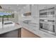 Modern kitchen with white cabinets, stainless steel appliances, and gas cooktop at 1917 S Lakemont Ave, Winter Park, FL 32792