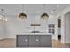 Modern kitchen with white cabinets, a large island, and gold pendant lights at 1917 S Lakemont Ave, Winter Park, FL 32792