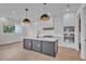 Modern kitchen with a large island, white cabinets, and gold pendant lights at 1917 S Lakemont Ave, Winter Park, FL 32792
