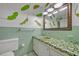 Bathroom with green tile and updated vanity at 700 Melrose Ave J 1 Ave # J1, Winter Park, FL 32789