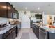 Modern kitchen features granite countertops, stainless steel appliances, and dark wood cabinetry at 25 Bahia Crse, Ocala, FL 34472