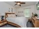 Cozy bedroom with a light wood bed frame and ceiling fan at 25 Bahia Crse, Ocala, FL 34472