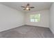 Spacious bedroom with ceiling fan and grey carpeting at 25 Bahia Crse, Ocala, FL 34472