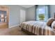 Bright bedroom with striped bedding and a view of a pond at 2892 Waterlily Way, Poinciana, FL 34759
