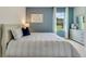 Relaxing bedroom with a gray accent wall and natural light at 2892 Waterlily Way, Poinciana, FL 34759