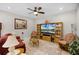 Relaxing living room with comfortable seating and a large flat-screen TV at 919 Braewood Dr, Clermont, FL 34715
