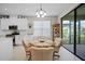 Bright breakfast nook with a round table, four chairs, and access to the backyard at 919 Braewood Dr, Clermont, FL 34715