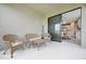 Covered patio with wicker furniture and view into kitchen at 919 Braewood Dr, Clermont, FL 34715