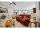 Bright living room with a red reclining sofa and view into the kitchen at 919 Braewood Dr, Clermont, FL 34715