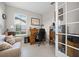 Home office featuring a wooden desk, comfortable seating, and built-in shelving at 919 Braewood Dr, Clermont, FL 34715