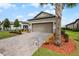 Two-car garage with paver driveway and landscaping at 919 Braewood Dr, Clermont, FL 34715