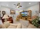 Comfortable living room with a large TV, cozy seating, and wood flooring at 919 Braewood Dr, Clermont, FL 34715