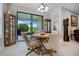 Cozy breakfast nook with a round table, four chairs, and access to a patio at 919 Braewood Dr, Clermont, FL 34715