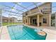 Inviting screened-in pool with two bright inflatable rings at 13530 Hawk Lake Dr, Orlando, FL 32837