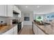 Modern kitchen with granite countertops and stainless steel appliances at 2888 Waterlily Way, Poinciana, FL 34759