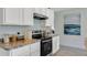 White shaker cabinets, granite counters, and stainless steel appliances at 2888 Waterlily Way, Poinciana, FL 34759
