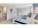 Bedroom with a dresser, ensuite bathroom and a large bed at 2888 Waterlily Way, Poinciana, FL 34759