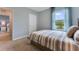 Bright bedroom with striped bedding and view of a pond at 2888 Waterlily Way, Poinciana, FL 34759