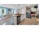 Open kitchen features stainless steel appliances and an island at 2888 Waterlily Way, Poinciana, FL 34759