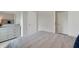 Serene bedroom with a striped comforter and mirrored dresser at 2888 Waterlily Way, Poinciana, FL 34759