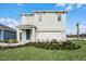 Two-story house with light beige exterior and a white garage door at 2888 Waterlily Way, Poinciana, FL 34759