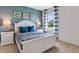 Spacious Primary bedroom with white bed frame and blue accents at 2888 Waterlily Way, Poinciana, FL 34759