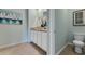 Bathroom with toilet and double vanity with granite countertop at 2888 Waterlily Way, Poinciana, FL 34759