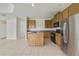 Bright kitchen boasts an island, stainless steel refrigerator, and wood cabinetry at 2839 Boating Blvd, Kissimmee, FL 34746