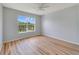 Light-filled bedroom with hardwood floors and a large window at 2839 Boating Blvd, Kissimmee, FL 34746
