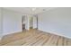 Bright bedroom with wood-look flooring, private bathroom access, and walk-in closet at 2839 Boating Blvd, Kissimmee, FL 34746