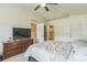 Main bedroom with a large bed and dresser, with bathroom access at 3090 Tioga Ter, Deltona, FL 32738