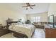 Bright bedroom with a large bed, couch, and plenty of natural light at 3090 Tioga Ter, Deltona, FL 32738