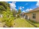 Landscaped backyard with lush greenery and a partially visible screened patio at 3090 Tioga Ter, Deltona, FL 32738