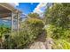 Backyard with screened patio, tropical plants, and a partially visible pool at 3090 Tioga Ter, Deltona, FL 32738